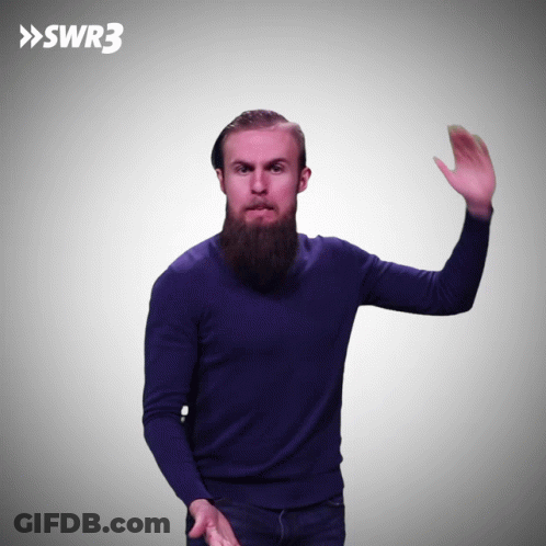 A Man In A Blue Sweater Is Waving His Hand In Front Of A Swr3 Logo GIF