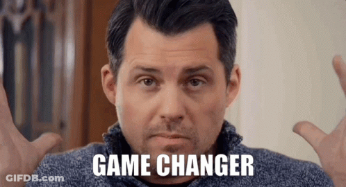 A Man In A Blue Sweater With The Words Game Changer On His Face GIF
