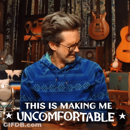 A Man In A Blue Sweater With The Words This Is Making Me Uncomfortable Below Him GIF