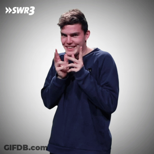 A Man In A Blue Sweatshirt Is Clapping In Front Of A Swr3 Sign GIF