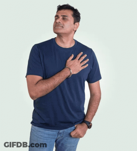 A Man In A Blue T-Shirt Is Holding His Hand To His Chest GIF