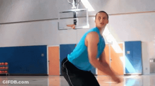 A Man In A Blue Tank Top And Black Pants Is Playing Basketball On A Court . GIF