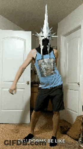 A Man In A Blue Tank Top And Shorts Is Dancing In A Room With The Words Byu Dorms Be Like Below Him GIF