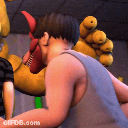 A Man In A Blue Tank Top Stands Next To A Stuffed Animal GIF