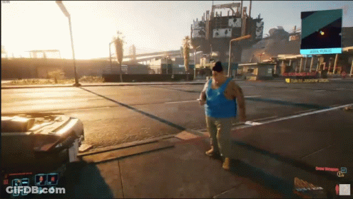 A Man In A Blue Tank Top Walking Down A Street In A Video Game GIF