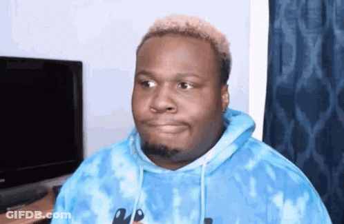 A Man In A Blue Tie Dye Hoodie Is Making A Funny Face GIF