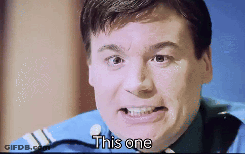 A Man In A Blue Uniform Is Making A Funny Face And The Words " This One " Are Next To Him GIF