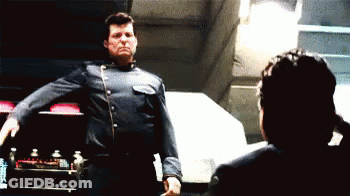 Man In Blue Uniform In Front Of Woman GIF