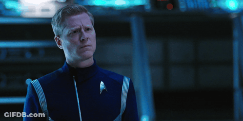 A Man In A Blue Uniform With A Star Trek Logo On The Front GIF