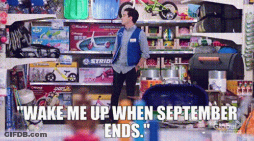 A Man In A Blue Vest Is Standing In Front Of A Shelf Of Toys . GIF