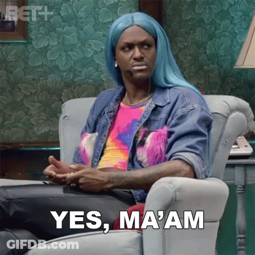 A Man In A Blue Wig Is Sitting In A Chair And Saying Yes Ma Am GIF