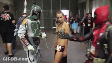 A Man In A Boba Fett Costume Is Holding A Woman In A Leia Costume GIF