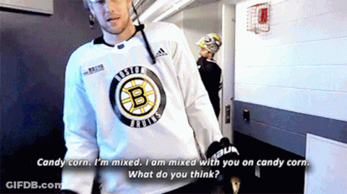 A Man In A Boston Bruins Jersey Talks To Another Man GIF