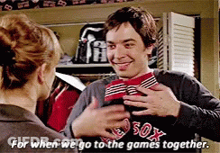 A Man In A Boston Red Sox Shirt Is Hugging A Woman GIF