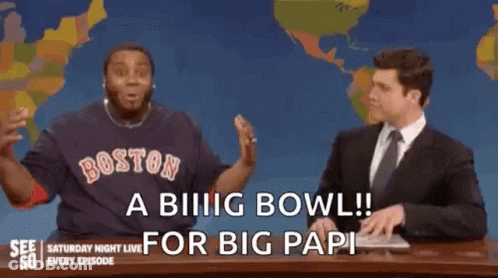 A Man In A Boston Red Sox Shirt Is Sitting Next To A Man In A Suit On A Saturday Night Live Show . GIF