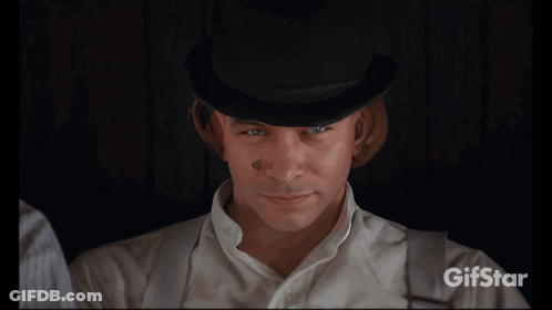 A Man In A Bowler Hat Is Drinking Milk From A Carton GIF