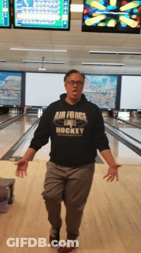 A Man In A Bowling Alley Wearing A Shirt That Says Air Force Hockey GIF