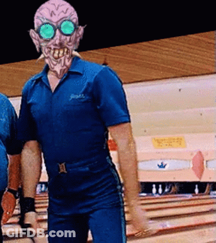 A Man In A Bowling Alley With A Mask On GIF