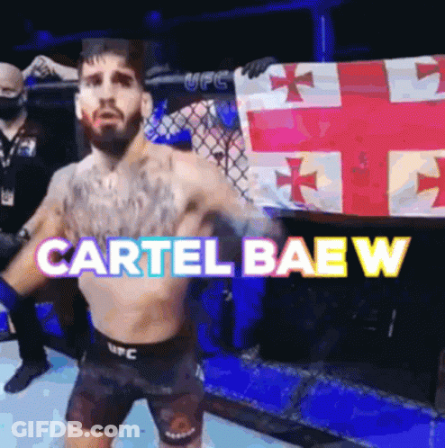 A Man In A Boxing Ring Is Holding A Flag And The Words Cartel Baew Are Above Him GIF