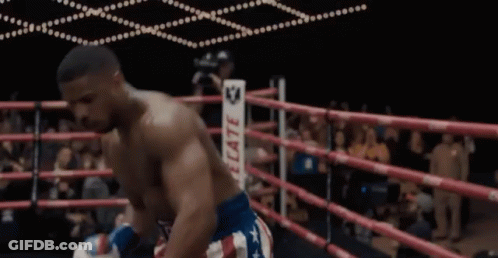 A Man In A Boxing Ring Wearing A Belt That Says ' Reed ' On It GIF
