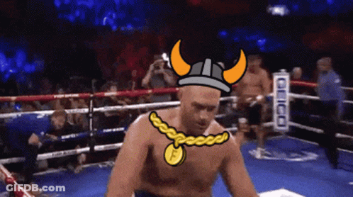 A Man In A Boxing Ring Wearing A Viking Helmet And A Necklace With The Letter F On It GIF