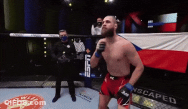 A Man In A Boxing Ring With A Banner That Says Scaped On It GIF