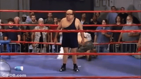 A Man In A Boxing Ring With A Blue Cup In The Corner GIF