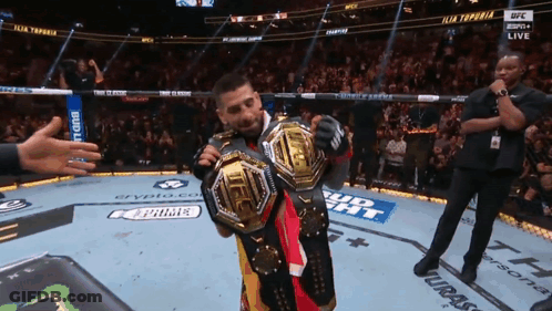 A Man In A Boxing Ring With A Bud Light Banner GIF