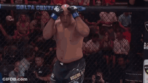 A Man In A Boxing Ring With A Delta Center Banner In The Background GIF
