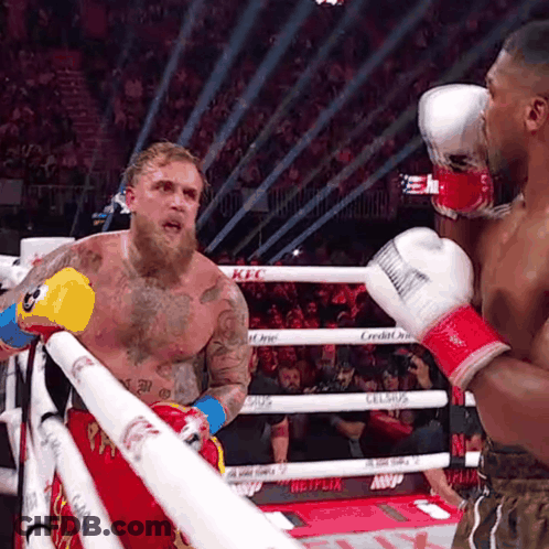 A Man In A Boxing Ring With A Netflix Logo On The Side GIF