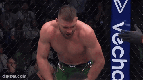 A Man In A Boxing Ring With A Sign That Says Avecha GIF