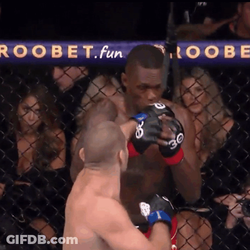 A Man In A Boxing Ring With A Sign That Says Roobet Fun GIF