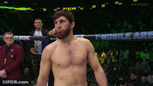 A Man In A Boxing Ring With A Sign That Says T Mobile Are Behind Him GIF