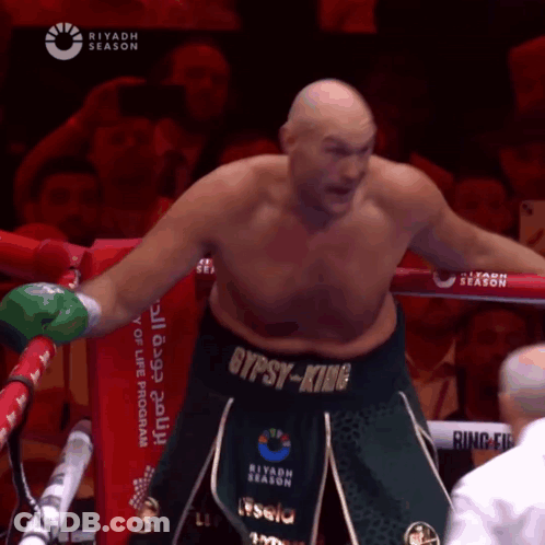 A Man In A Boxing Ring With The Word Gypsy-King On His Belt GIF