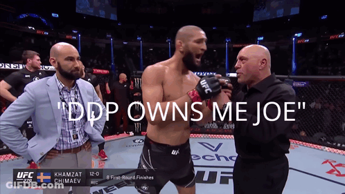 A Man In A Boxing Ring With The Words " Ddp Owns Me Joe " At The Top GIF
