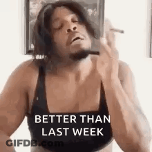 A Man In A Bra Is Smoking A Cigarette While Wearing A Bra . GIF