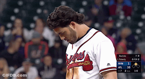 A Man In A Braves Jersey Looks Down At The Scoreboard GIF