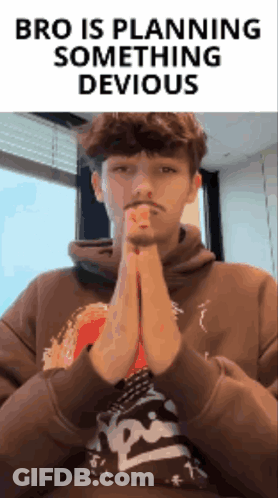 A Man In A Brown Hoodie Is Praying With The Words Bro Is Planning Something Devious Behind Him GIF