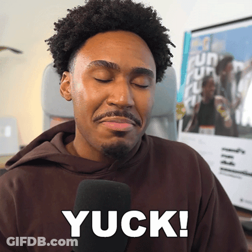 A Man In A Brown Hoodie Is Talking Into A Microphone And Says Yuck GIF