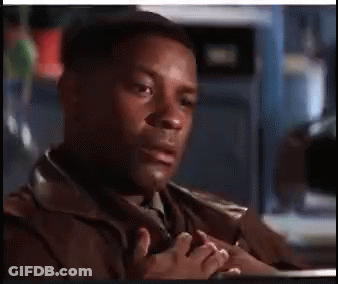 A Man In A Brown Jacket And Tie Is Sitting At A Table With His Hands Folded . GIF