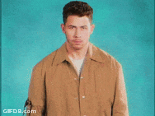 A Man In A Brown Jacket Covering His Mouth With His Hands And The Words Pretends To Be Shocked GIF