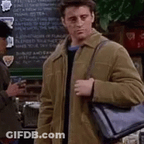 A Man In A Brown Jacket Is Holding A Black Bag And Asking What Are You Referring To My Man 'S Bag ? GIF