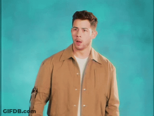 A Man In A Brown Jacket Is Making A Surprised Face . GIF