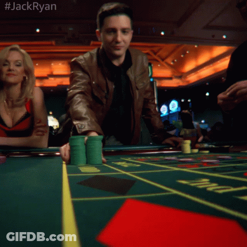 A Man In A Brown Jacket Is Playing Roulette In A Casino With The Hashtag #Jackryan GIF