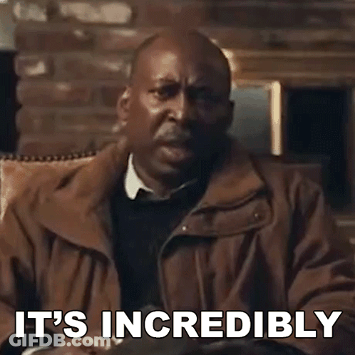A Man In A Brown Jacket Is Sitting In A Chair With The Words `` It 'S Incredibly '' Written On The Screen . GIF