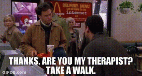 A Man In A Brown Jacket Is Talking To Another Man In A Restaurant .. GIF