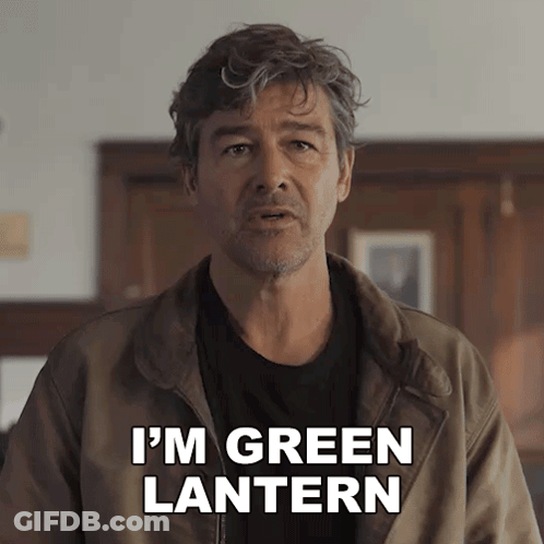 A Man In A Brown Jacket Says " I 'M Green Lantern " To The Camera GIF