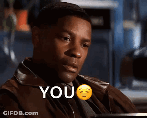 A Man In A Brown Jacket Says " You " With A Smiley Face GIF