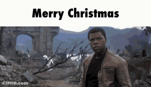 A Man In A Brown Jacket Stands In Front Of A Ruined Building With The Words Merry Christmas Written Above Him GIF