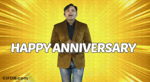 A Man In A Brown Jacket Stands In Front Of A Yellow Background That Says Happy Anniversary GIF